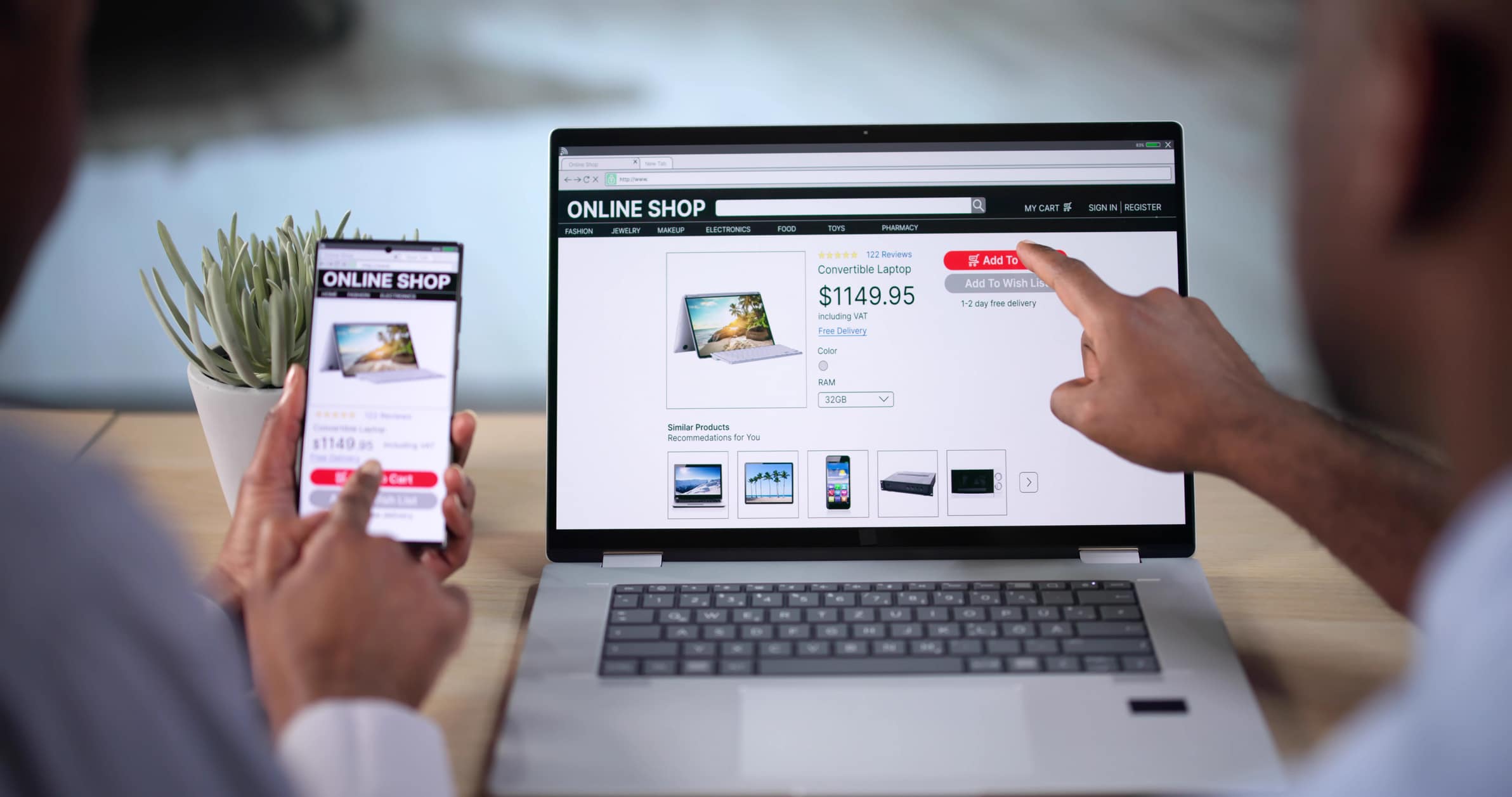 Business owners view their website on mobile and laptop.