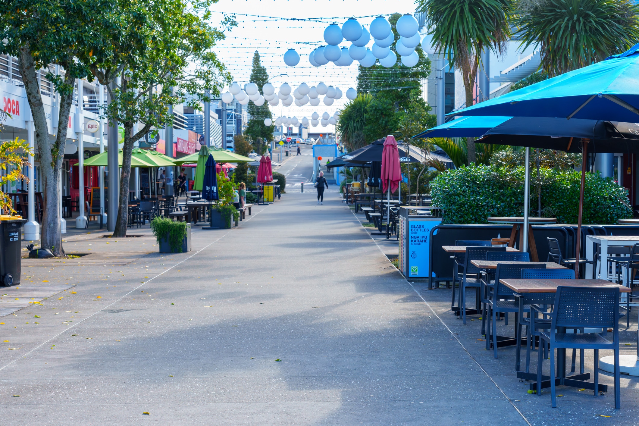 Tauranga street with multiple cafes with outdoor seating.