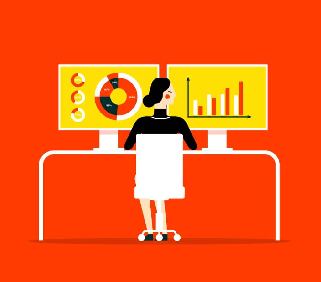 A woman sits at a desk to review her business analytics.